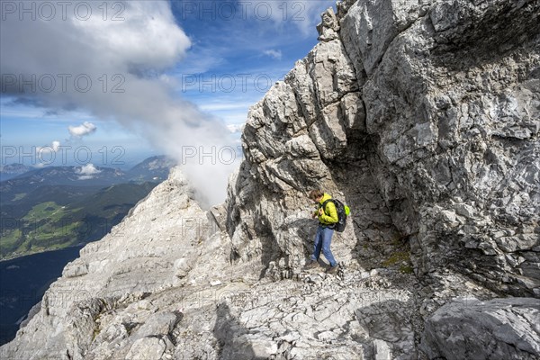 Mountaineer on a narrow rocky ridge, Watzmann crossing to Watzmann Mittelspitze, view of mountain panorama, Berchtesgaden National Park, Berchtesgaden Alps, Bavaria, Germany, Europe