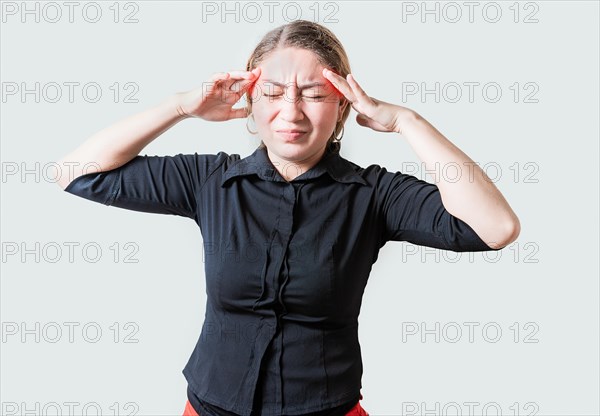 Young woman with headache isolated. Portrait of girl suffering from migraine on isolated background. Headache concept
