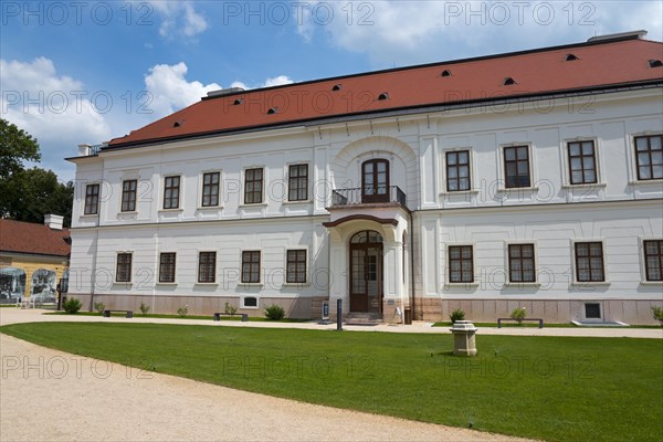 Baroque castle with white facade and red roof, path leading to a central door, Esterhazy Castle, Tata, Totis, Lake Oereg, Komarom-Esztergom, Central Transdanubia, Hungary, Europe