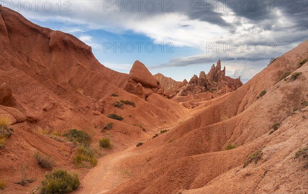 Eroded mountain landscape, sandstone cliffs, canyon with red and orange rock formations, Konorchek Canyon, Chuy, Kyrgyzstan, Asia