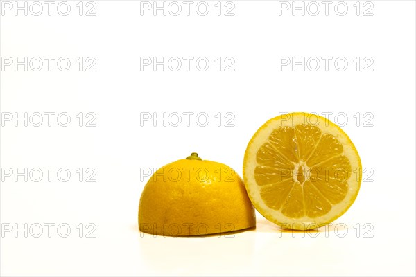 Close-up of a fresh lemon cut in half isolated on white background and copy space