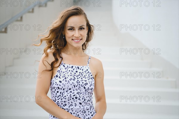 Urban portrait of smiling young woman