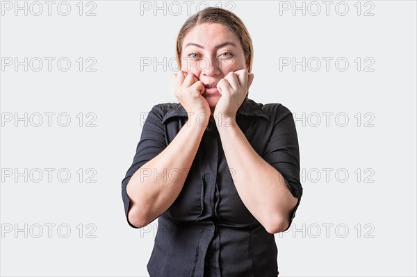 Worried girl biting her nails isolated. Anxious person biting her nails, looking at camera