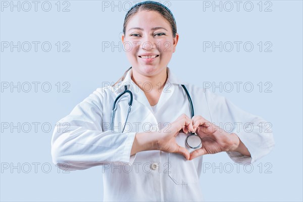 Smiling doctor making heart shape on isolated background. Friendly female doctor making heart gesture with hands isolated