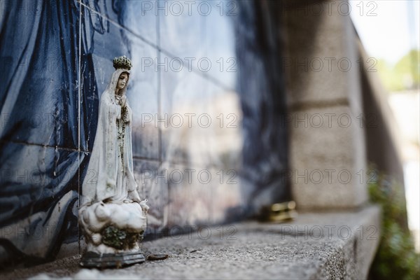 Holy Mary statue with the religious background made of Portuguese traditional tiles, Porto, Portugal, Europe