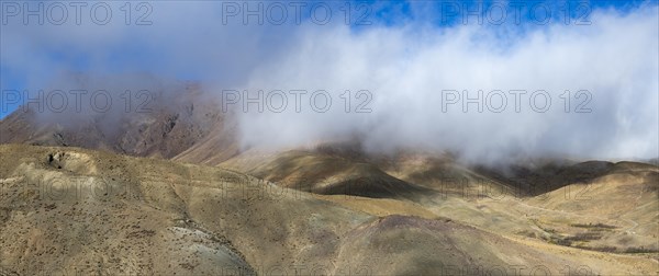 Low hanging clouds in the mountain landscape at the Tizi-n-Tichka pass road, High Atlas, Morocco, Africa