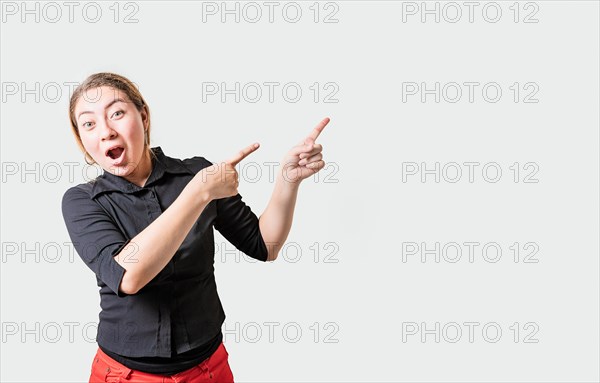 Amazed girl pointing an advertising side. Astonished girl pointing to a banner to the side. people pointing a promo