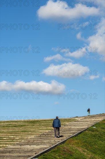 Person climbing a large staircase in a park in Madrid