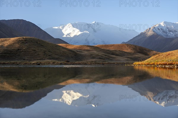 Morning atmosphere, mountains reflected in a small mountain lake, Pik Lenin, Trans Alay Mountains, Pamir Mountains, Osh Province, Kyrgyzstan, Asia