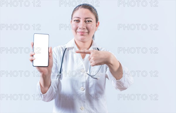 Beautiful female doctor holding and pointing at phone screen. Young female doctor showing and pointing at smatphone screen isolated