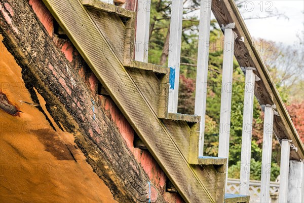 Closeup of wooden outdoor staircase on old abandoned building