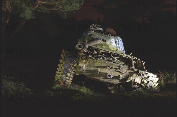 An old tank illuminated at night in the forest with dramatic light, M41 Bulldog, Lost Place, Brander Wald, Aachen, North Rhine-Westphalia, Germany, Europe