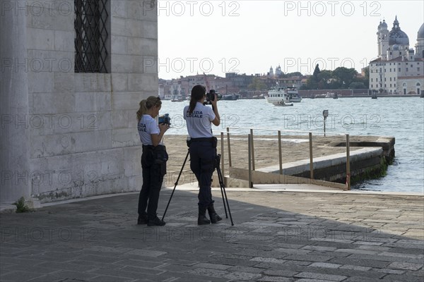 Police laser speed measurement on the island of San Giorgio Maggiore, on the waterfront of the Guidecca Canal, Dorsoduro district, Venice, Veneto, Italy, Europe