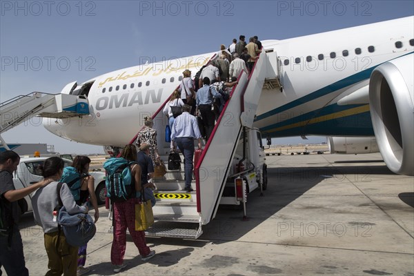Passengers boarding Oman Airways plane, Seeb International Airport, Muscat, Oman, Asia