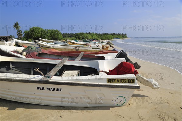Boats and fishing canoes tropical beach at Pasikudah Bay, Eastern Province, Sri Lanka, Asia