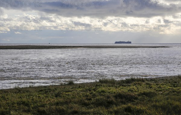 North Weir Point tip end of Orford Ness shingle spit, River Ore, Shingle Street, Suffolk, England, UK distant MSC container ship in North Sea