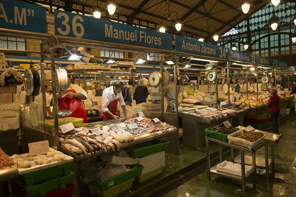 People shopping at fishmonger stalls inside historic covered market building, Jerez de la Frontera, Spain, Europe