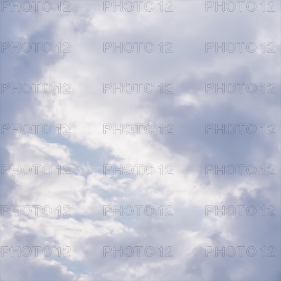 Cloudy sky background with sunlight shining through white clouds. Natural backdrop