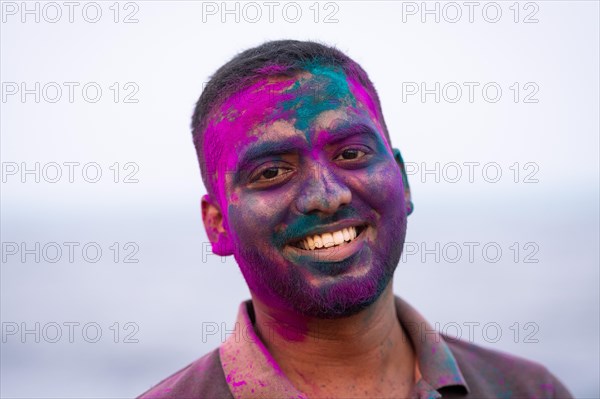 Man with colour on his face, Holi Festival, Indian spring festival, traditional festival of colours, Pondicherry or Puducherry, Tamil Nadu, India, Asia