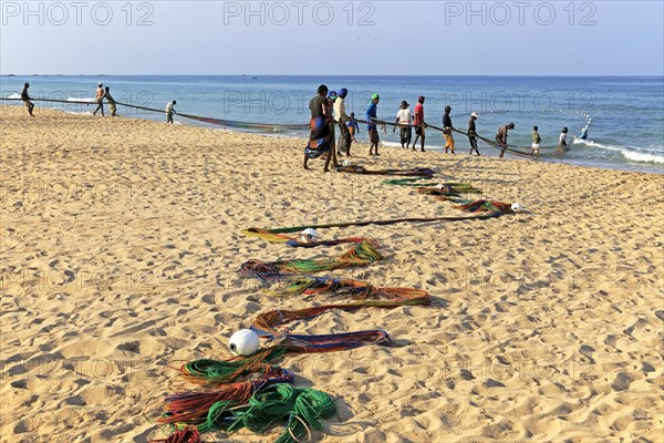 Traditional fishing hauling nets Nilavelli beach, near Trincomalee, Eastern province, Sri Lanka, Asia