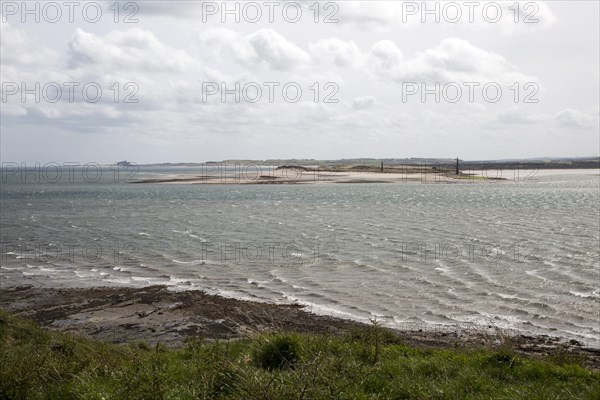 Narrow coastal channel between mainland and Holy Island, Lindisfarne, Northumberland, England, UK