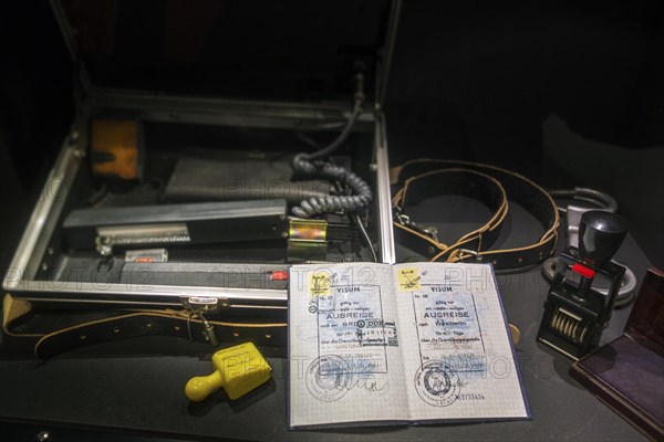 Passport with visas for West-Berlin and FRG and ID check kit including UV control apparatus used by East German STASI officers at the Memorial de Caen, museum and war memorial in Caen, Normandy, France, Europe