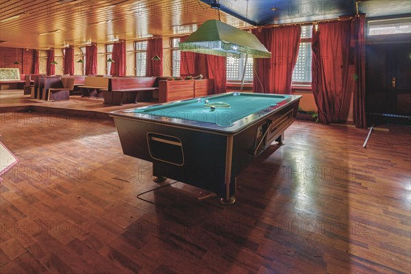 Cosy billiard room with a large table and red curtains, Bad am Park, Lost Place, Essen, North Rhine-Westphalia, Germany, Europe