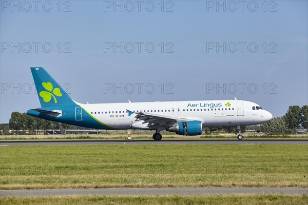 Aer Lingus Airbus A320-214 with registration EI-DVK lands on the Polderbaan, Amsterdam Schiphol Airport in Vijfhuizen, municipality of Haarlemmermeer, Noord-Holland, Netherlands