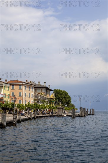 Waterfront promenade with restaurants in Gargnano, Lake Garda, Province of Brescia, Lombardy, Italy, Europe