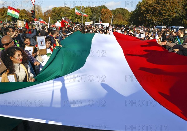Iranians demonstrate in Berlin with a large Iranian flag to support the protests in Iran. The demonstration was called by the Woman Life Freedom Collective, Berlin, 22.10.2022