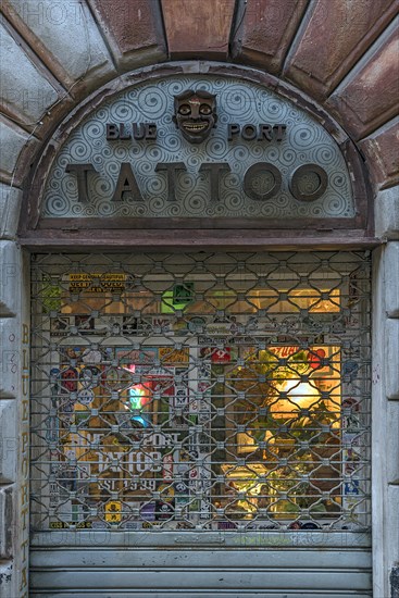 Barred tattoo parlour Blue Port Tattoo, after closing time, Via S. Donato, 63 r Genoa Italy