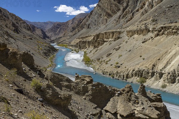Tsarab River, cutting across the Zanskar Range of the Himalayas in Ladakh, with barren mountains above it, seen on a clear, blue-sky day, late in the summer, when glacier rivers like this one slow down, carry less sediment and become turquoise blue. Kargil District, Union Territory of Ladakh, India, Asia