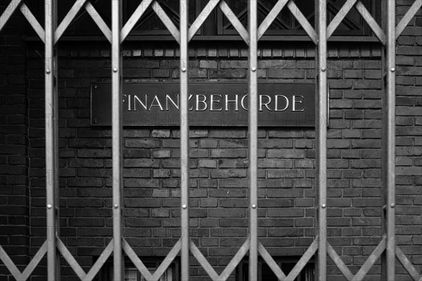 Sign with inscription Finanzbehoerde, behind bars, Hanseatic City of Hamburg, Hamburg, Germany, Europe