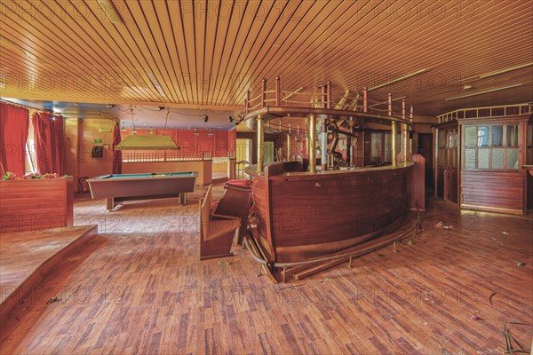 An empty and run-down bar room with a pool table and red curtains, Bad am Park, Lost Place, Essen, North Rhine-Westphalia, Germany, Europe