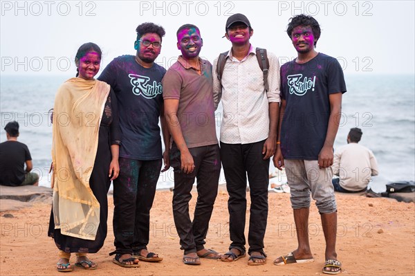 Group of young people with colour on their faces, Holi Festival, Indian spring festival, traditional festival of colours, Pondicherry or Puducherry, Tamil Nadu, India, Asia