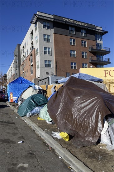 Denver, Colorado, Immigrants, mostly from Venezuela, live in a tent camp near downtown Denver. The city helped about 35, 000 migrants in 2023 with food and temporary shelter, but more continue to arrive daily on buses from the southern border