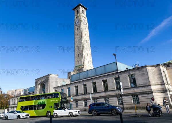 Traffic on street by clocktower of city council headquarters municipal offices, Southampton, Hampshire, England, UK