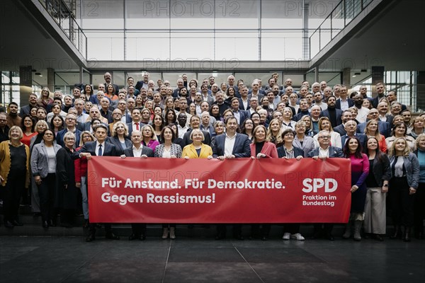 SPD Bundestag parliamentary group photographed as part of a group photo in the Paul Loebe Haus with a banner: For decency. For democracy. Against racism. In the front row from (L-R) Rolf Muetzenich, Chairman of the SPD parliamentary group, Ol