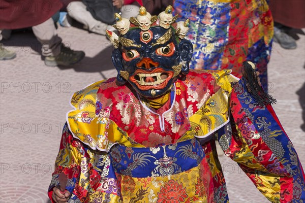 A monk performing cham, the sacred religious masked dance, during the Spituk Gustor winter festival in the Spituk Gompa, the Buddhist monastery near Leh, the capital of Ladakh. Many inhabitants of this Indian region, which is often called Little Tibet, follow the Tibetan Buddhism. District Leh, Union Territory of Ladakh, India, Asia