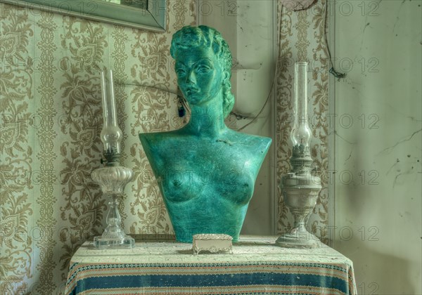A green bust between two candlesticks on a table in front of a window, Maison Limmi, Lost Place, Kalken, Laarne, Province of East Flanders, Belgium, Europe
