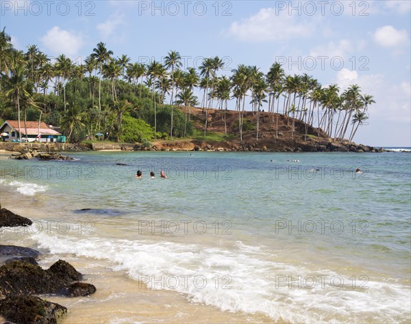 Tropical beach with people swimming Mirissa, Sri Lanka, Asia