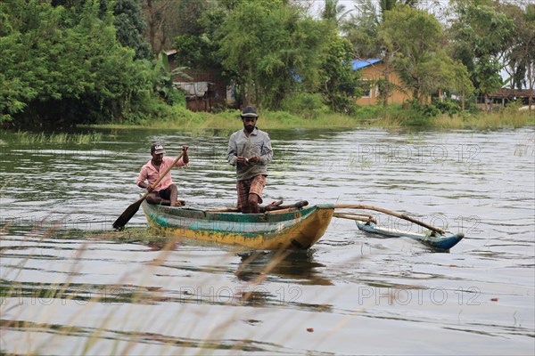 Men fishing from a canoe, Polonnaruwa, Central Province, Sri Lanka, Asia