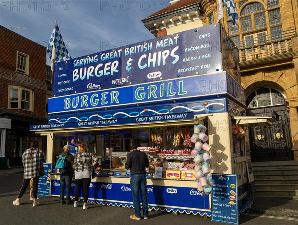 Mops fair fairground, High Street, Marlbrough, Wiltshire, England, UK October 7th 2023, Burger and chips grill stall