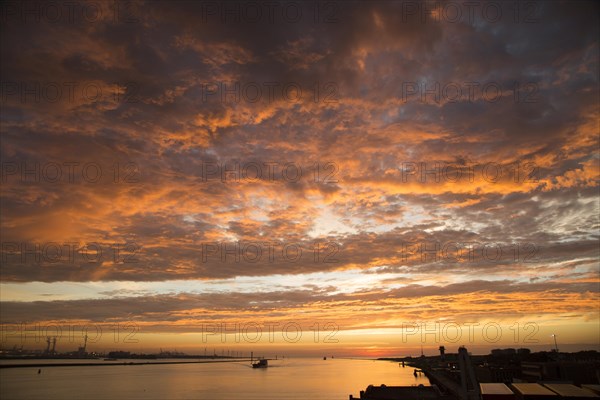 Sunset orange glow landscape clouds water, North Sea shipping, Port of Rotterdam, Hook of Holland, Netherlands