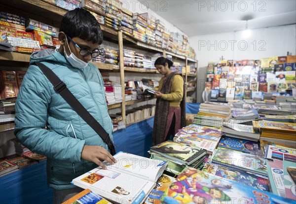 Book readers browsing books at a stall during Assam Book Fair, in Guwahati, Assam, India on 29 December 2023