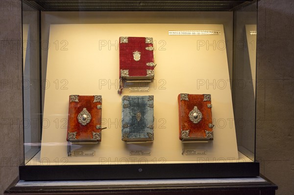 Glass display case of historic bible books inside the cathedral, former Great mosque, Cordoba, Spain, Europe