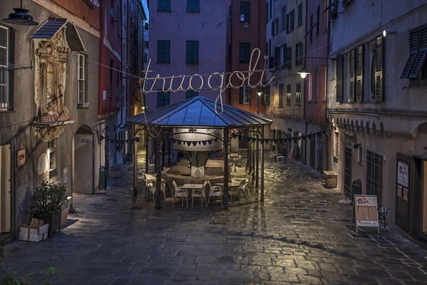 Rerstaurant seats in the evening in a historic public wash house, Piazza Truogoli di Santa Brigida, Genoa, Italy, Europe