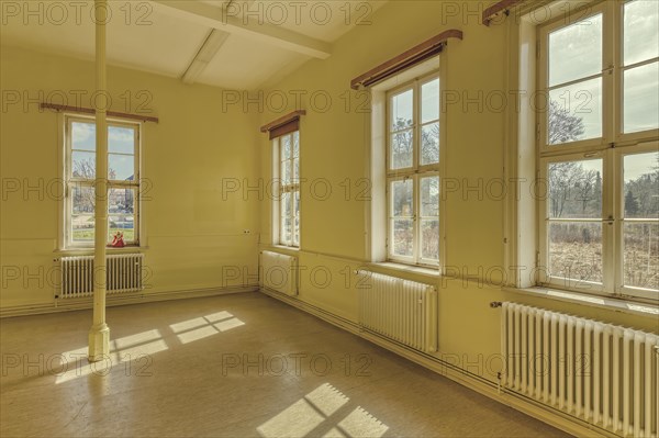 A sunlit, plain room with yellow walls and white radiators, Schachtrupp Villa, Lost Place, Osterode am Harz, Lower Saxony, Germany, Europe