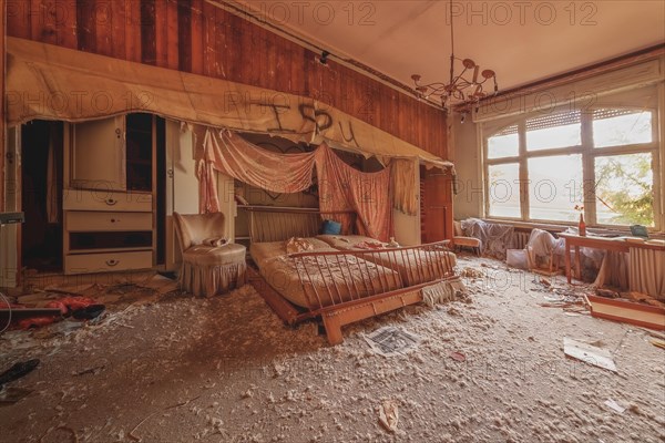 An abandoned and devastated bedroom with overturned furniture and graffiti on the wall, urologist's villa Dr Anna L., Lost Place, Bad Wildungen, Hesse, Germany, Europe