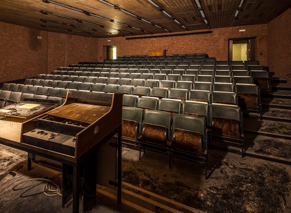 A dark lecture theatre with heavily worn seats and an abandoned lectern, Biotech, abandoned university, Lost Place, Sint-Genesius-Rode, Belgium, Europe